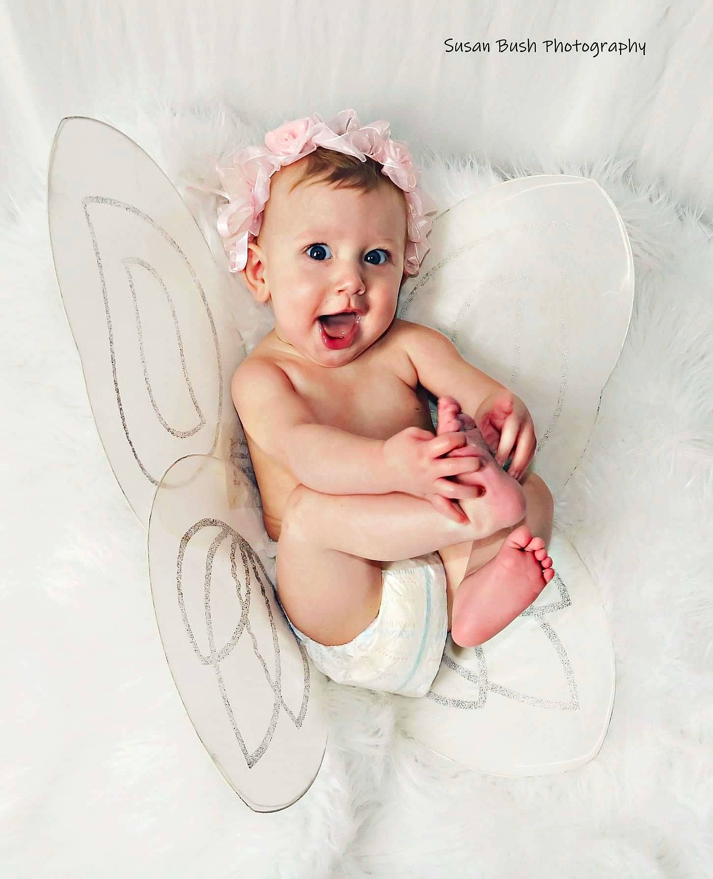 Patricia is registered to the contest to win money with this photo: angel, child, fictional_character, hair_accessory, infant, person, supernatural_creature, surprise, toddler