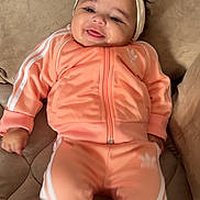 Anya participe au concours pour gagner de l'argent avec cette photo : baby, child, smiling, headband, couch, tracksuit, adidas, clothing, infant, happy, portrait, indoors, cute, sitting, soft_furniture, person, fashion, cozy, young_child, comfortable