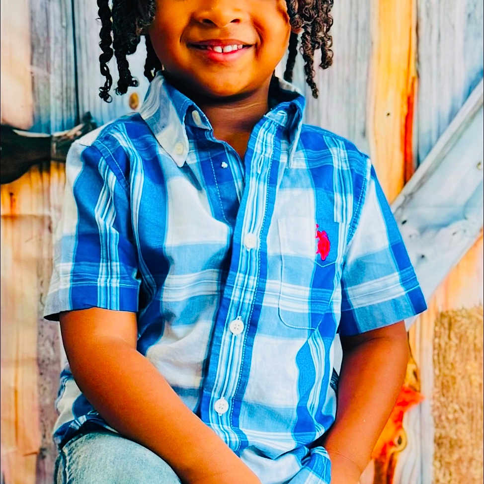 Brendan joined the competition — help win amazing prizes! child, boy, smiling, braided_hair, blue_shirt, jeans, autumn_leaves, pumpkin, rustic_background, fall, festive, portrait, posing, happy, indoors, colorful, casual_clothing, cute, seasonal, decoration