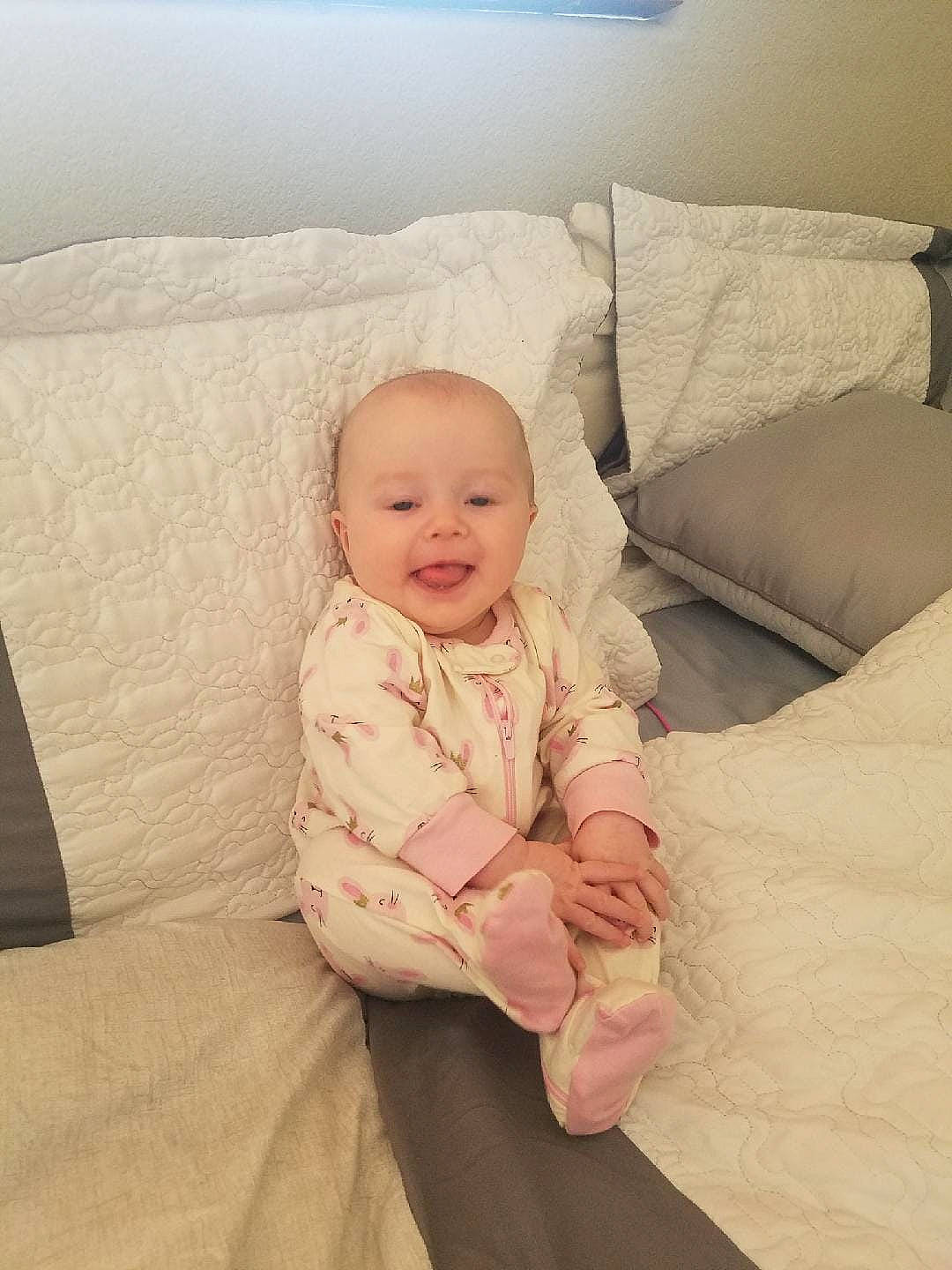 Lily Rose joined the competition — help win amazing prizes! baby, beige, cheek, child, comfort, face, finger, furniture, head, leg, person, pink, product, room, sitting, skin, smile, toddler, vacation