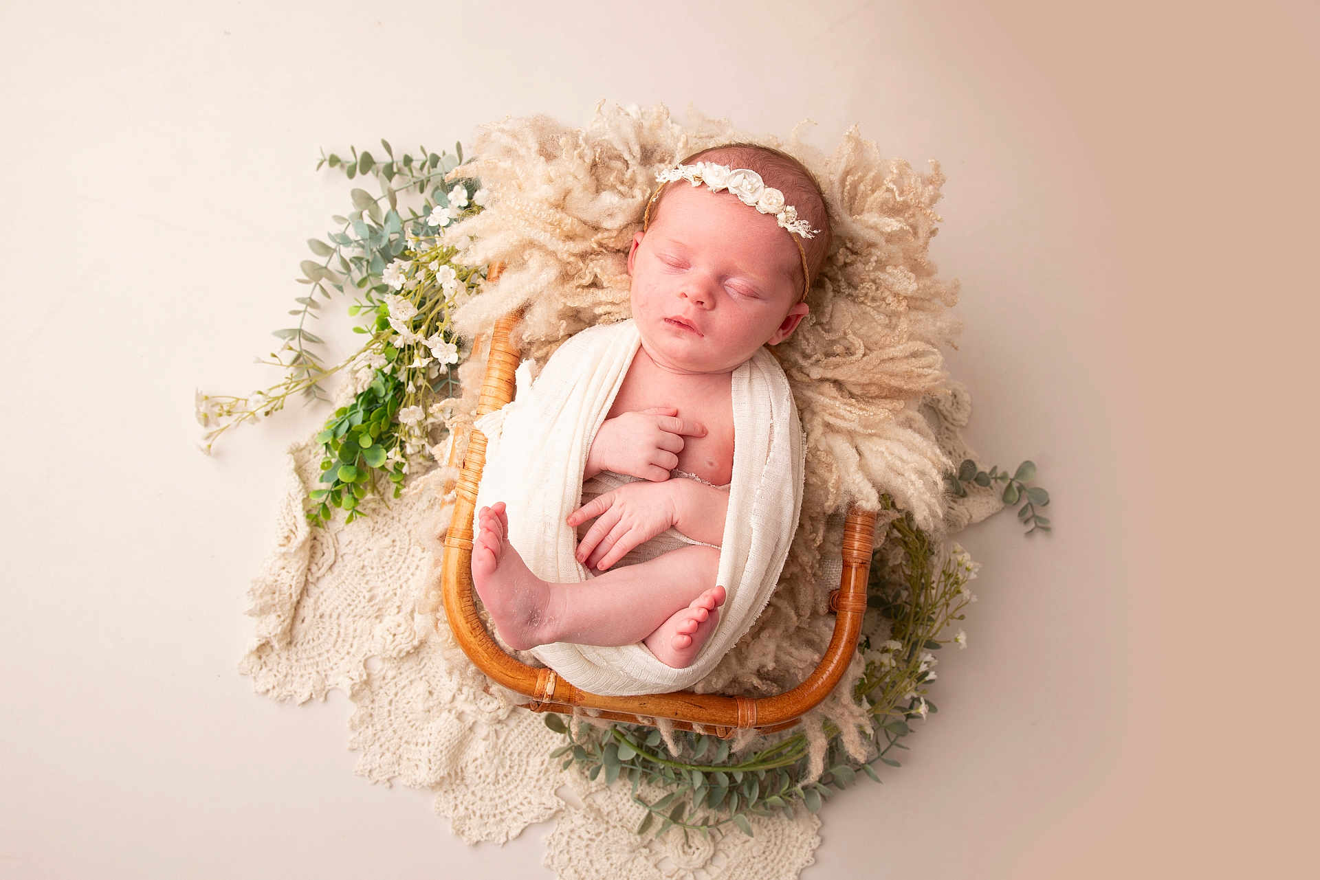 Edie is registered to the contest to win money with this photo: newborn, baby, sleeping, basket, blanket, headband, flower_crown, greenery, lace, soft_texture, cozy, portrait, infant, peaceful, cute, wrapped, resting, indoor, closeup, adorable