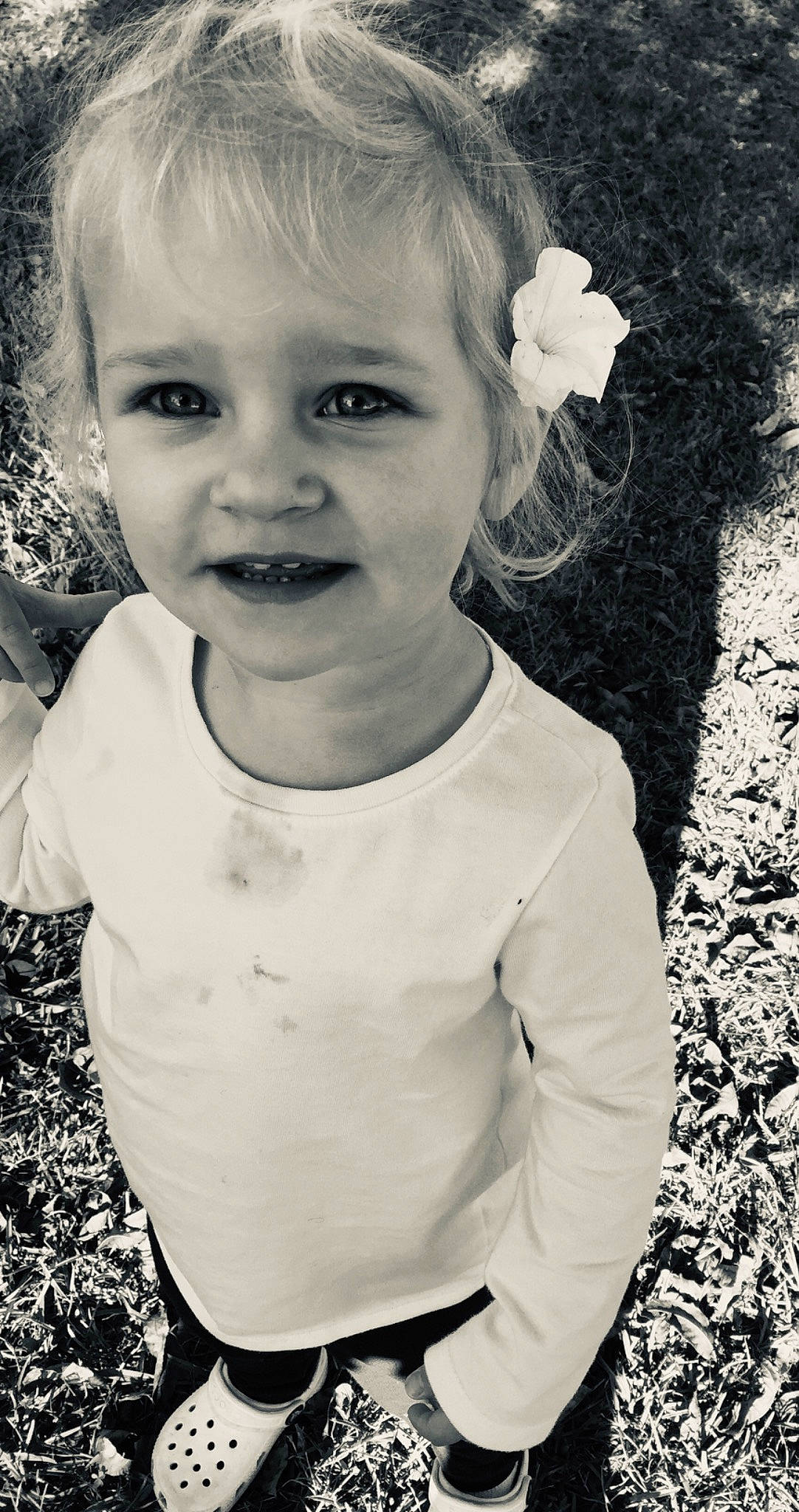 Scarlett joined the competition — help win amazing prizes! black, black_and_white, facial_expression, flash_photography, gesture, grass, hairstyle, happy, iris, lip, monochrome, nose, people_in_nature, person, photograph, sleeve, smile, standing, style, toddler