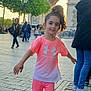 Melya participe au concours pour gagner de l'argent avec cette photo : child, smiling, pink_clothing, sportswear, sneakers, outdoor, tourist, landmark, arc_de_triomphe, trees, pavement, people, daylight, urban, city, happy, posing, casual, street, fashion
