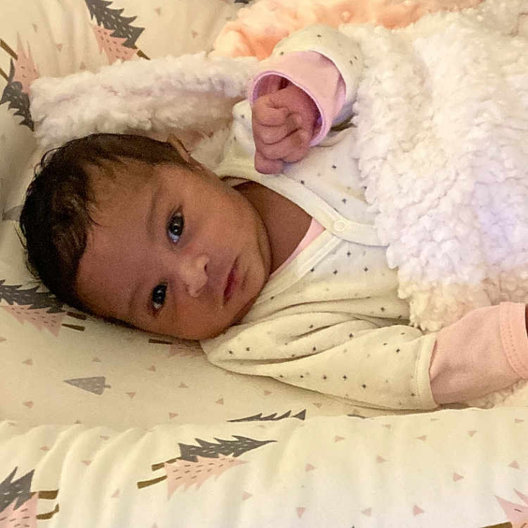 Allyah participe au concours pour gagner de l'argent avec cette photo : baby, blanket, child, comfort, cozy, cushion, cute, face, indoor, infant, lying_down, newborn, patterned, pillow, pink, portrait, resting, sleepwear, soft, white