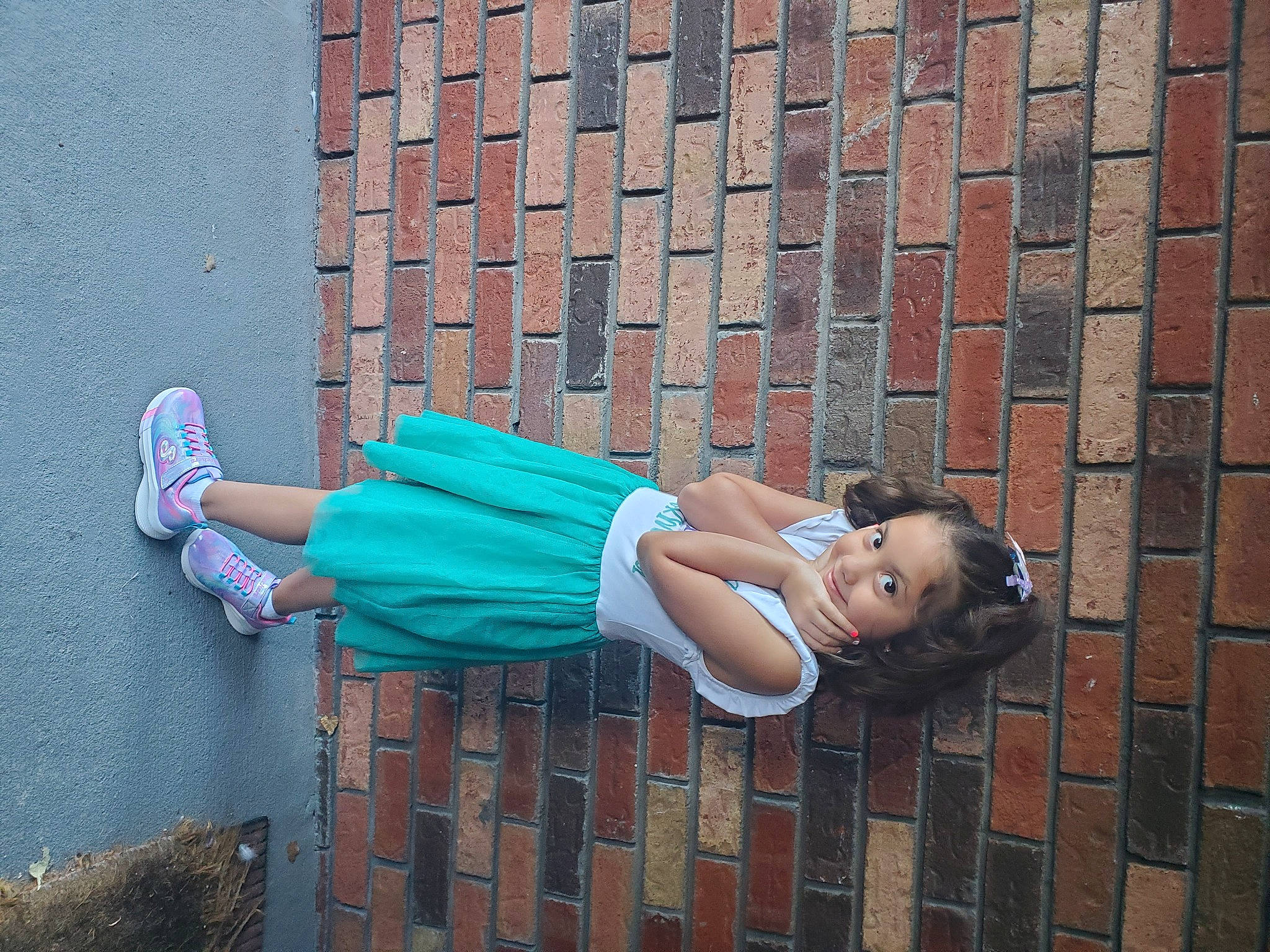 Angelina joined the competition — help win amazing prizes! beauty, brick, brickwork, electric_blue, eyewear, facade, footwear, human_leg, knee, pattern, person, road_surface, sandal, shoe, sidewalk, sitting, street, thigh, waist, wall