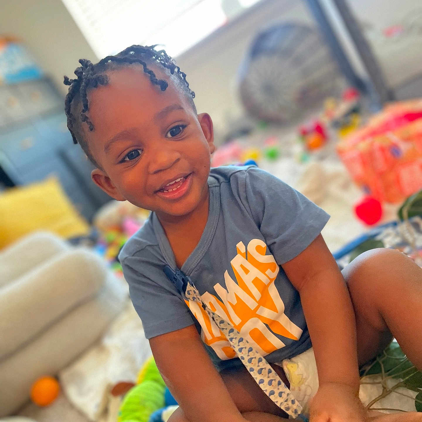 Jahmari joined the competition — help win amazing prizes! ball, boy, child, clothing, couch, face, football, furniture, hair, happy, head, indoors, male, person, photography, portrait, shorts, sitting, smile, t_shirt