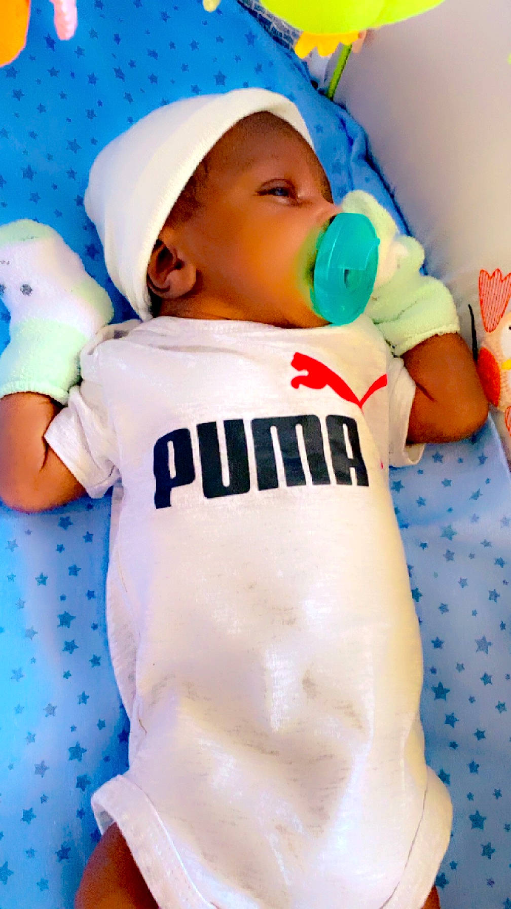 Hezekiah joined the competition — help win amazing prizes! baby, baby_products, baby_sleeping, baby_toddler_clothing, blue, cap, child, finger, gesture, happy, hat, pattern, person, personal_protective_equipment, play, sleeve, t_shirt, thumb, toddler, white