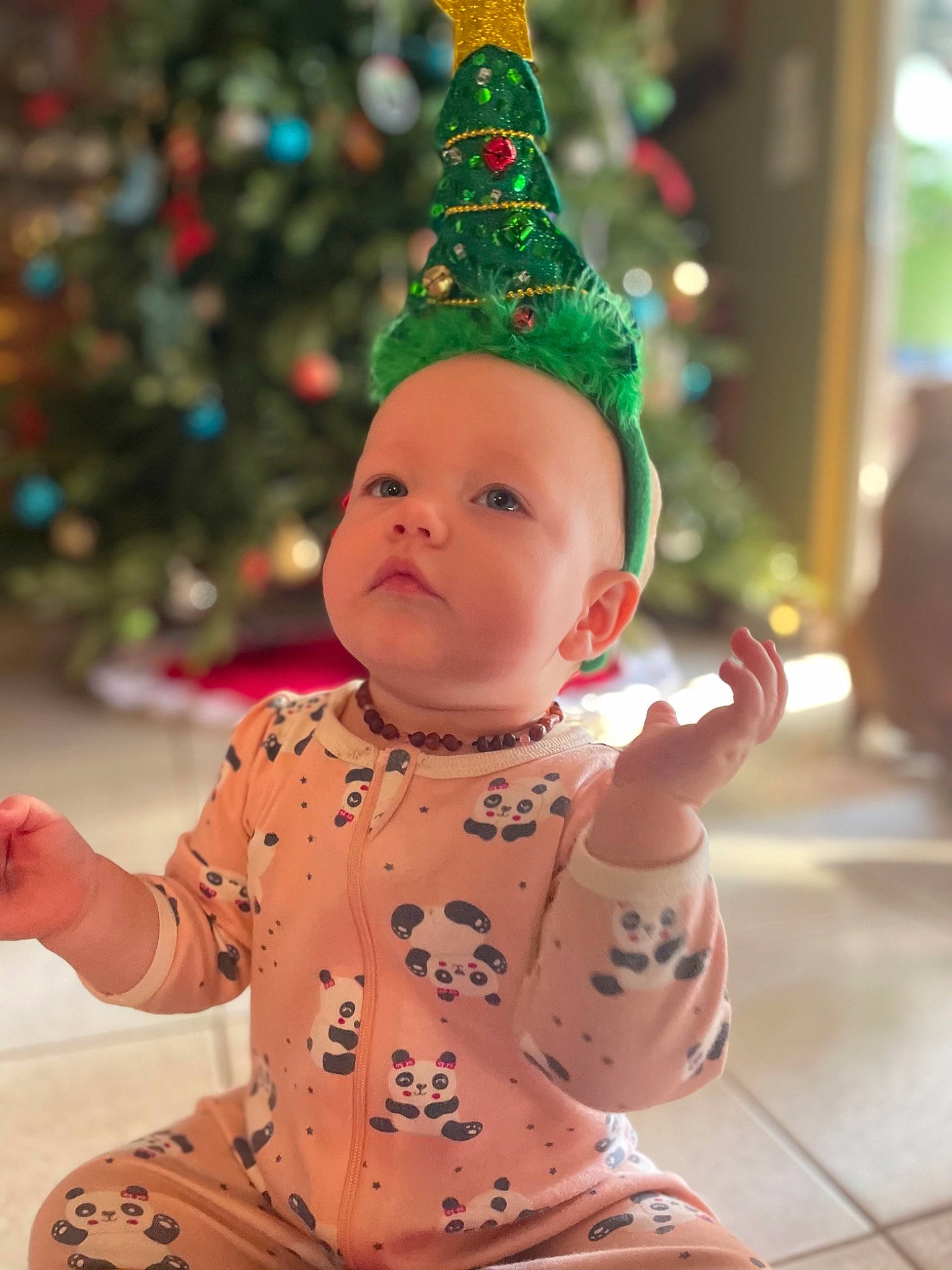 Avery is registered to the contest to win money with this photo: abdomen, baby, baby_toddler_clothing, christmas, christmas_decoration, christmas_eve, christmas_lights, christmas_ornament, christmas_tree, conifer, costume_accessory, costume_hat, finger, hand, holiday, holiday_ornament, ornament, party_supply, person, thumb