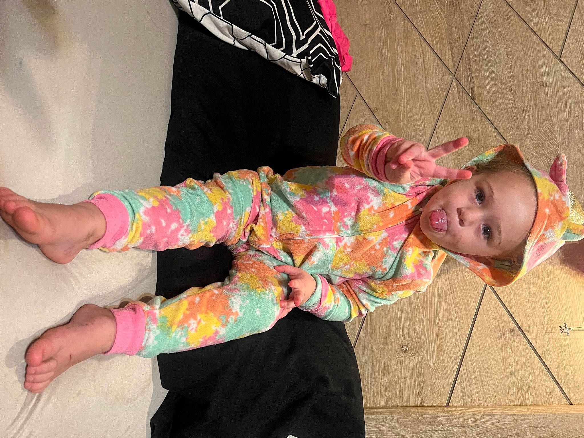 Oakley is registered to the contest to win money with this photo: baby_toddler_clothing, child, fashion_design, foot, fun, happy, human_leg, knee, magenta, pattern, person, pink, sandal, sitting, sleeve, smile, sock, textile, thigh, toddler