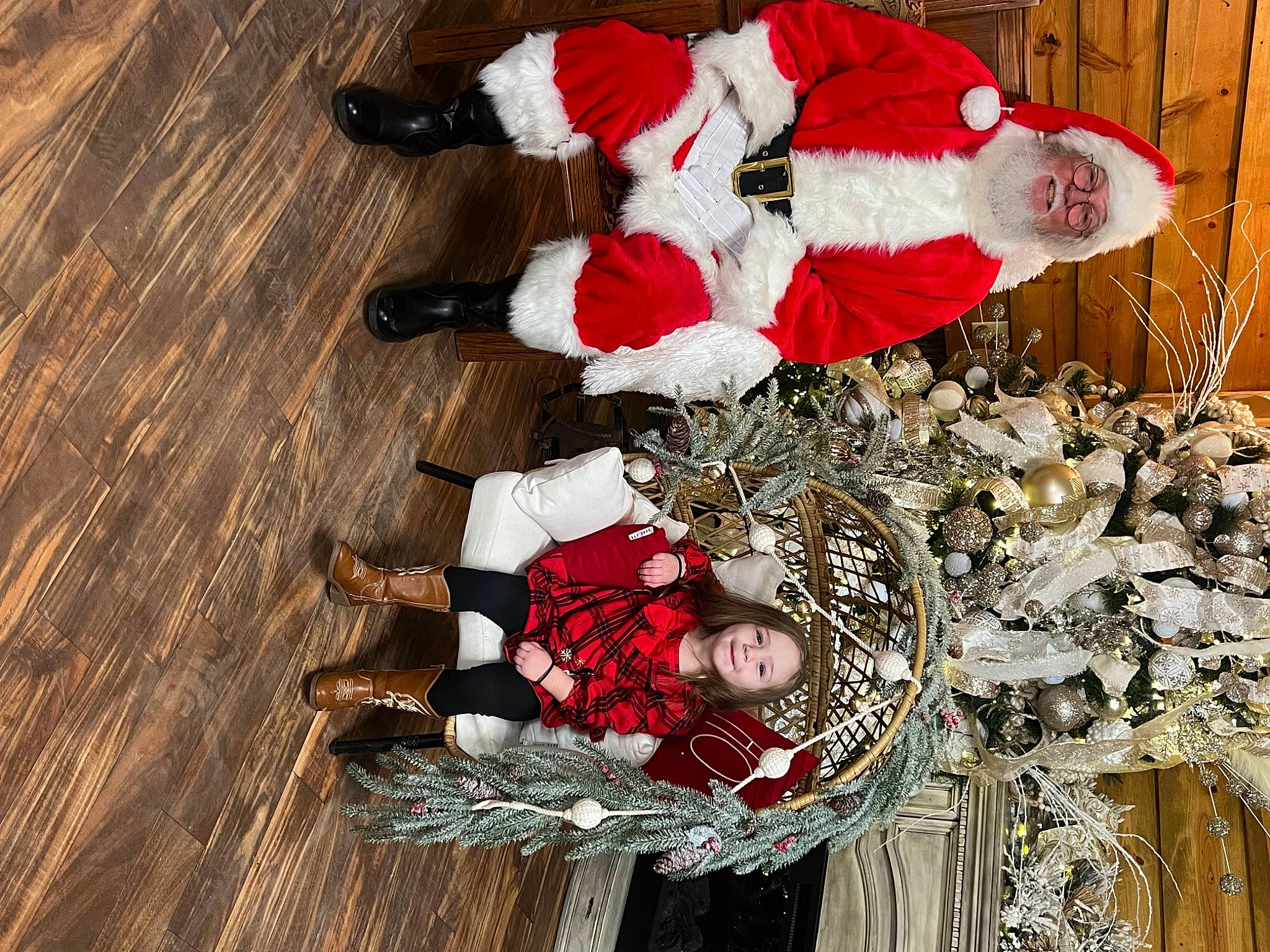 Oakley is registered to the contest to win money with this photo: carmine, christmas, christmas_decoration, christmas_eve, christmas_ornament, event, flooring, fur, hardwood, headwear, holiday, interior_design, person, plant, red, santa_claus, smile, tradition, tree, winter