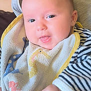 Maéna participe au concours pour gagner de l'argent avec cette photo : baby, infant, face, tongue, bib, striped_clothing, hand, cute, person, child, smiling, skin, cheeks, eyes, expression, holding, fabric, clothing, closeup, portrait