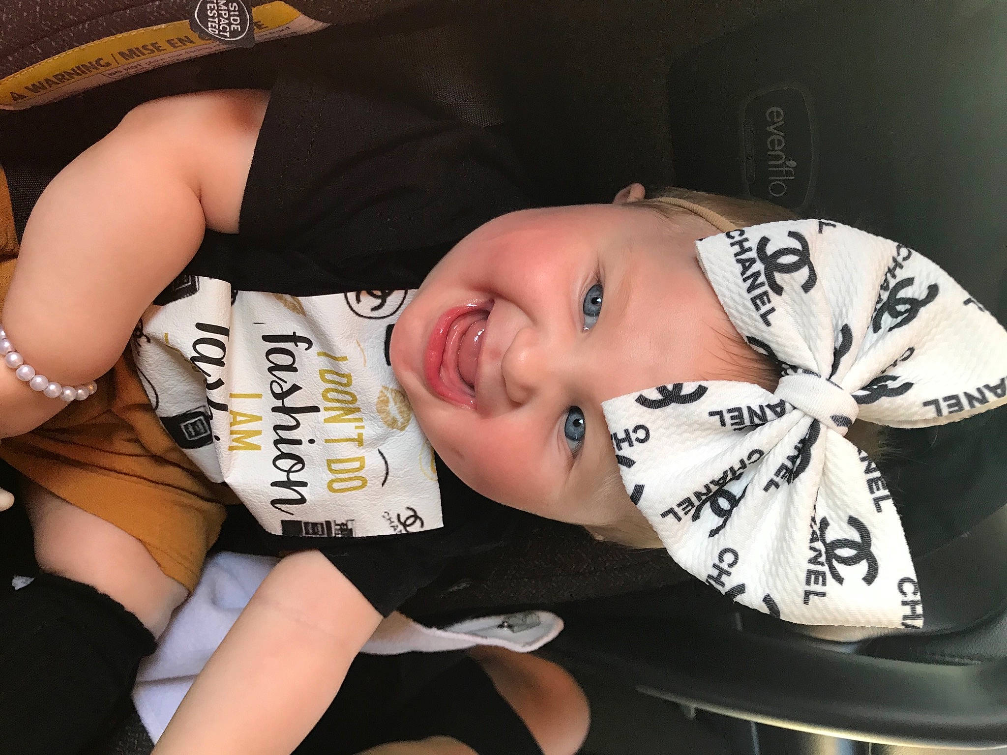 Madelyn Marie is registered to the contest to win money with this photo: abdomen, bangs, black_hair, chest, child, elbow, eyelash, fashion_accessory, fun, happy, headwear, human_leg, jewellery, knee, pattern, person, smile, thigh, toddler, trunk