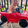 Jay joined the competition — help win amazing prizes! baby, backyard, barefoot, child, cute, daylight, face, foot, happy, outdoor, parked_car, person, playground, red, seat, smiling, steering_wheel, summer, toy_car, vehicle