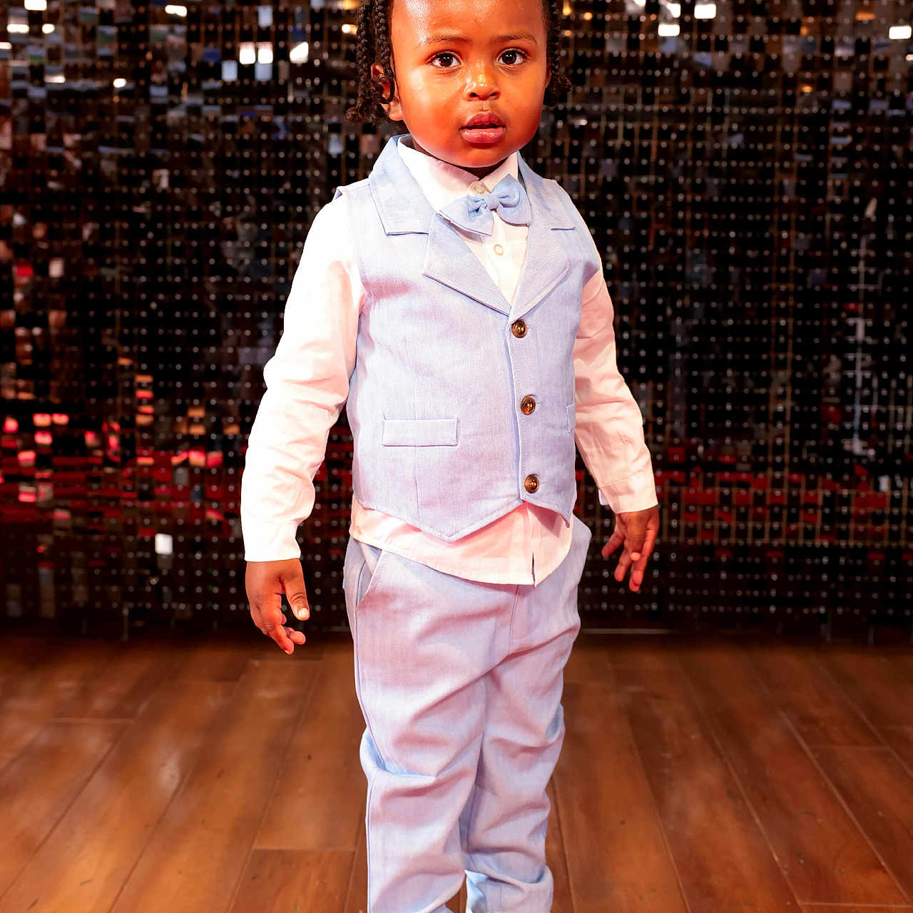 Marlin is registered to the contest to win money with this photo: boy, child, clothing, coat, face, footwear, formalwear, hardwood, head, jacket, male, pants, performer, person, photography, portrait, shoe, standing, suit, wood