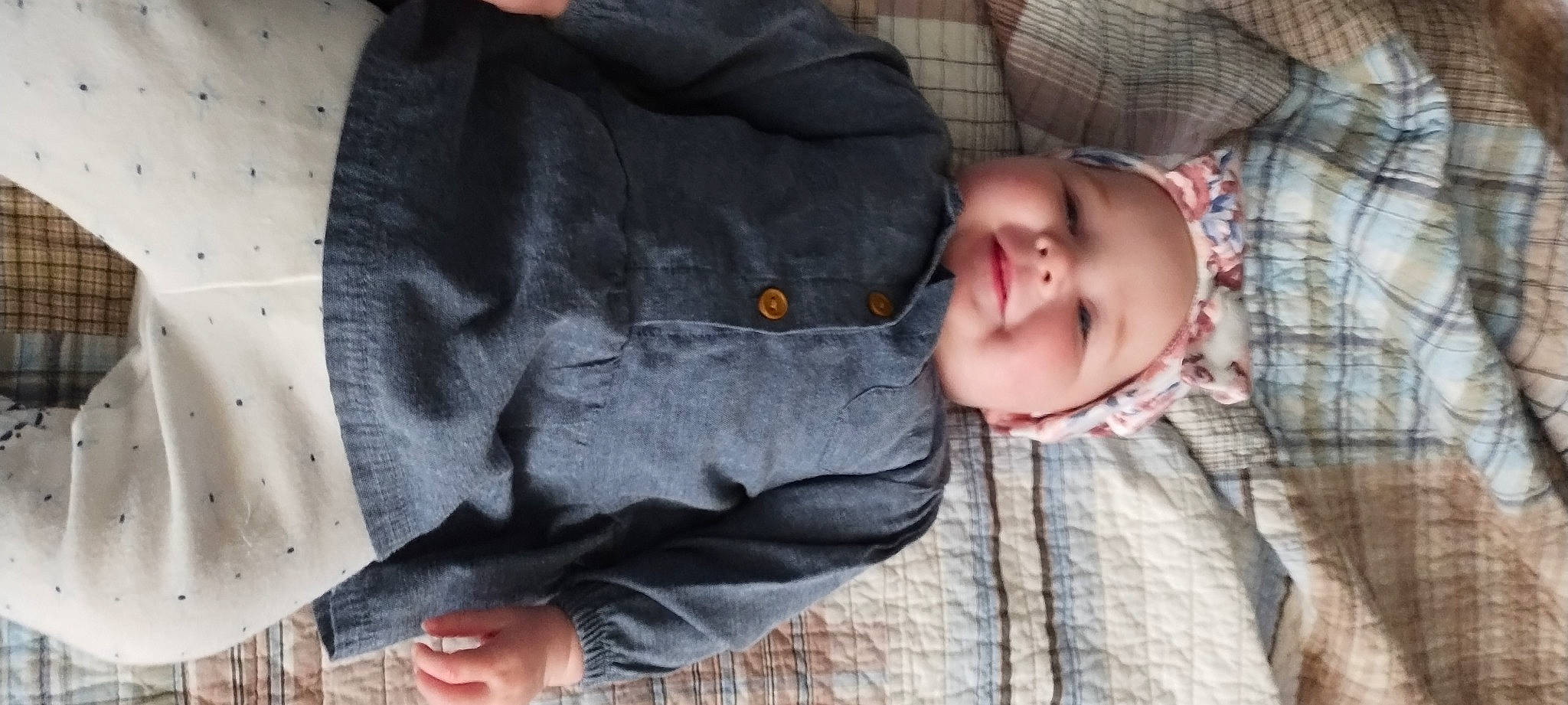 Rebecca is registered to the contest to win money with this photo: baby, baby_toddler_clothing, cheek, child, comfort, fur, grass, grey, head, headwear, military_camouflage, outerwear, pattern, person, sitting, skin, sleeve, textile, toddler, tree