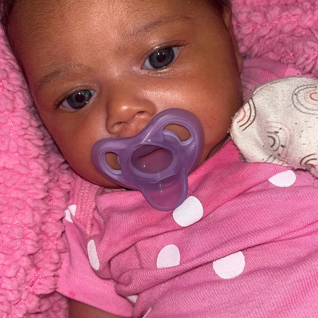 Isabella joined the competition — help win amazing prizes! baby, child, close_up, comfort, cozy, cute, eyes, face, hair, human, infant, lying_down, newborn, pacifier, pink_blanket, pink_clothing, polka_dot, portrait, skin, soft_texture