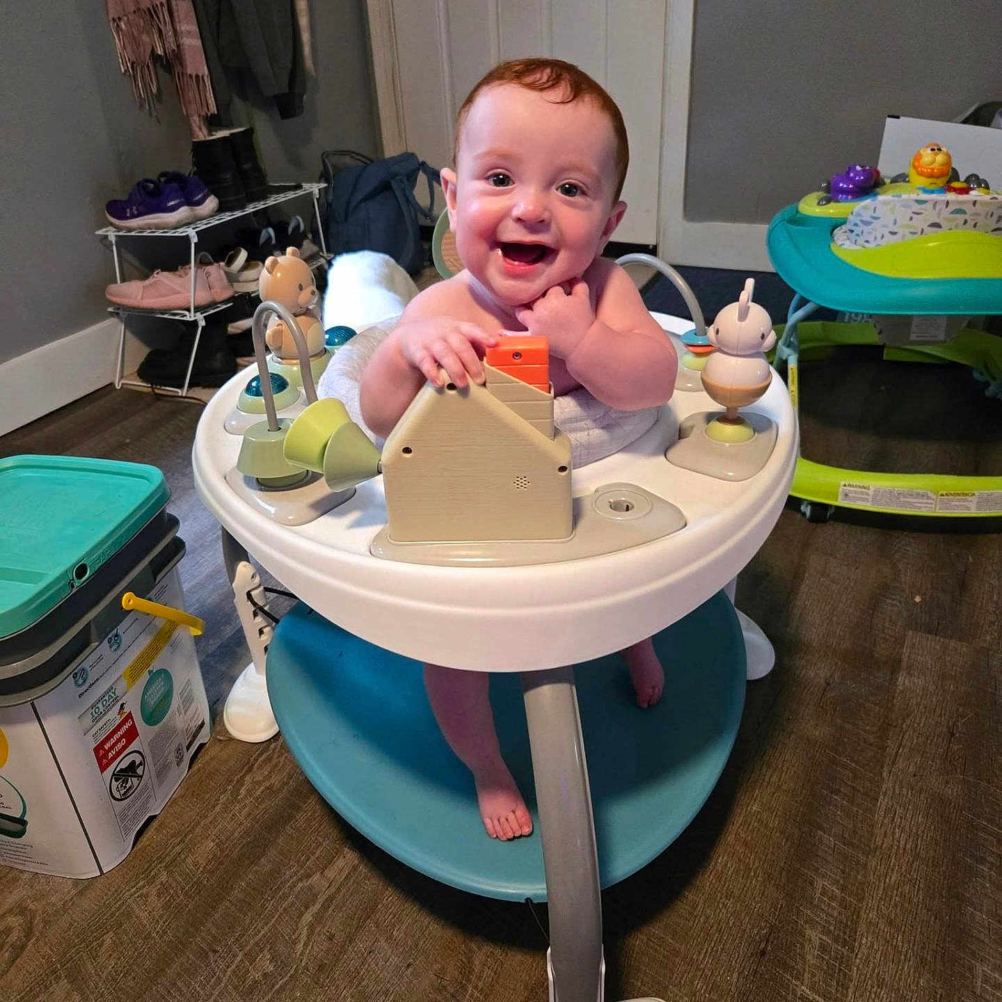 Sam joined the competition — help win amazing prizes! activity_center, baby, child, clothing, door, feet, floor, furniture, happy, home, indoor, infant, person, play, room, shelf, shoes, smiling, toys, wooden_floor