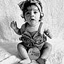 adorable, baby, big_eyes, black_and_white, bow, child, clothing, curly_hair, cute, expression, headband, indoor, infant, portrait, sitting, six_months, soft_blanket, studio, wooden_sign, young