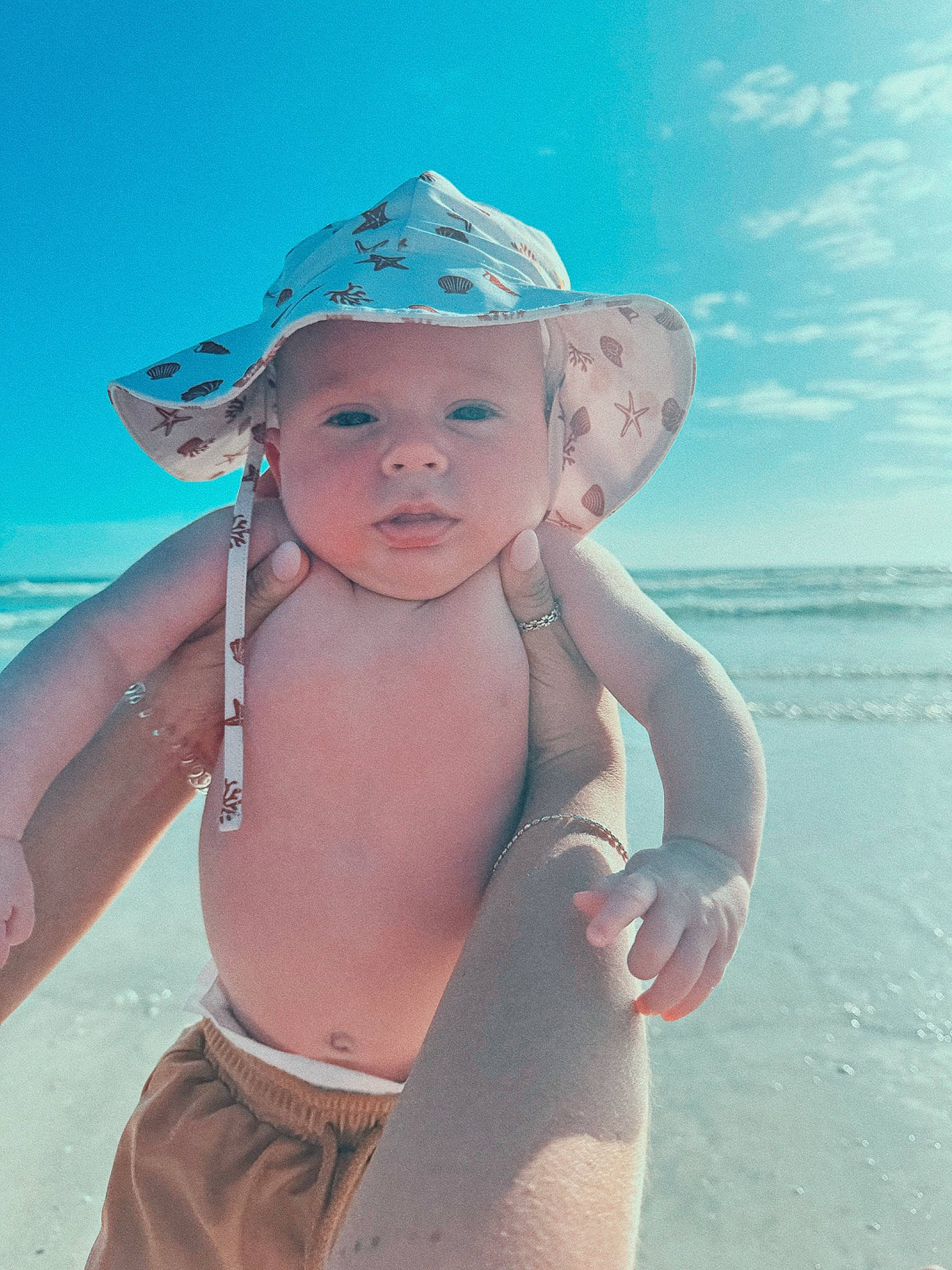 Dallas is registered to the contest to win money with this photo: aqua, azure, baby, beach, cap, cloud, flash_photography, fun, happy, hat, headgear, headwear, leisure, people_on_beach, person, skin, sky, sun_hat, swimwear, toddler