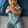 baby, infant, smiling, blue_striped_clothing, romper, pacifier, bed, bedding, pillow, happy, cute, child, person, indoor, portrait, hands, feet, socks, face, lying_down
