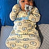 Phoenix joined the competition — help win amazing prizes! baby, pacifier, blue_hat, bear_pattern, onesie, infant, child, cute, lying_down, soft_texture, blue_socks, bed, quilt, comfortable, indoors, portrait, smiling, young_child, cozy, sleepwear