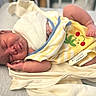 newborn, baby, sleeping, blanket, yellow, striped, frog_design, hospital_id, infant, wrapped, soft, skin, peaceful, resting, cute, small, bed, indoors, person, child
