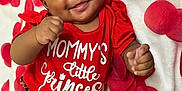Azlyn joined the competition — help win amazing prizes! adorable, baby, celebration, child, cute, feet, floral_pattern, hands, happy, headband, infant, lying_down, milestone, months, portrait, red_clothing, rose_petals, smiling, white_blanket, wooden_blocks