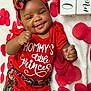 adorable, baby, celebration, child, cute, feet, floral_pattern, hands, happy, headband, infant, lying_down, milestone, months, portrait, red_clothing, rose_petals, smiling, white_blanket, wooden_blocks