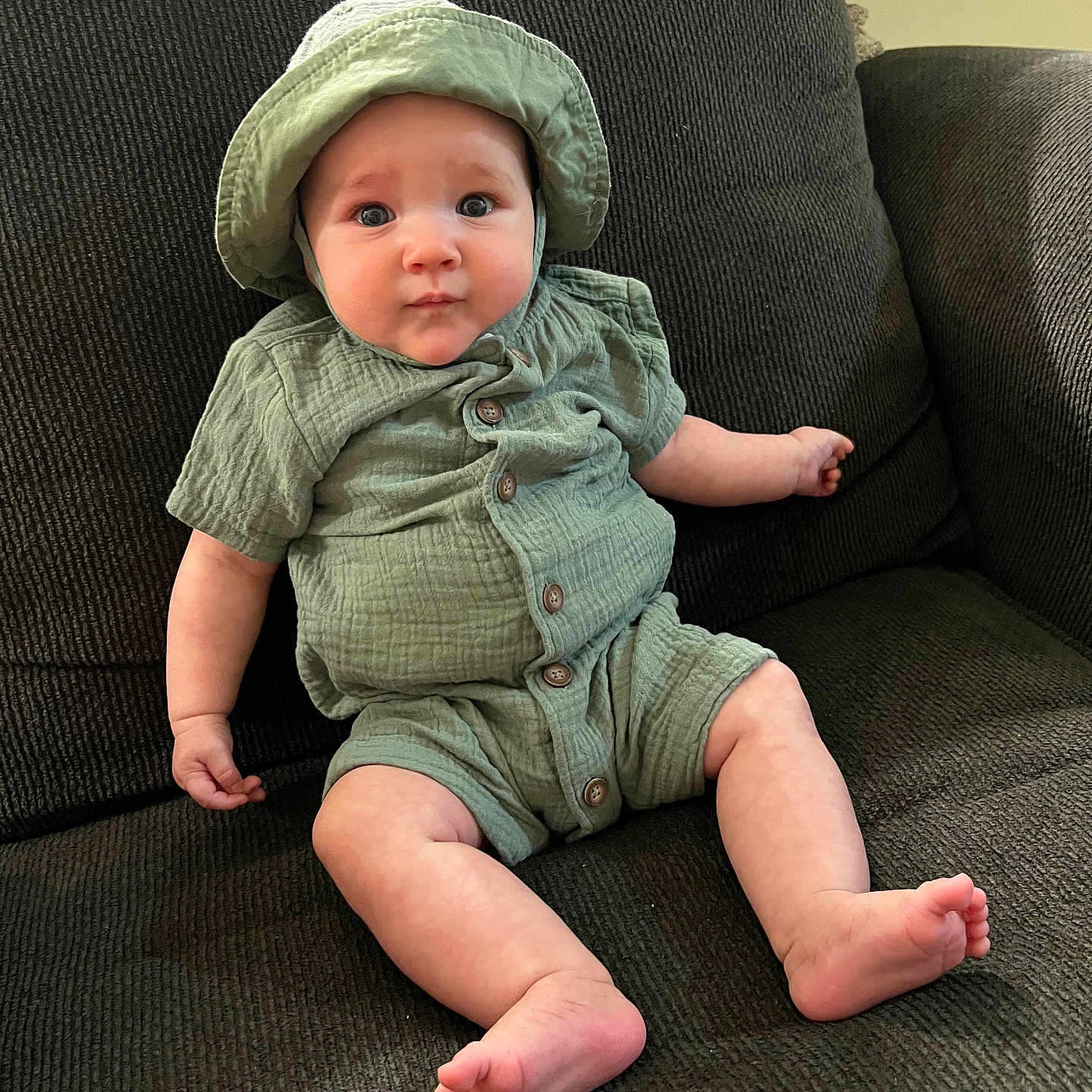 Hunter is registered to the contest to win money with this photo: baby, bonnet, cap, chair, clothing, couch, cushion, face, furniture, hat, head, homedecor, jeans, pants, person, photography, portrait, shorts, sitting, sunhat