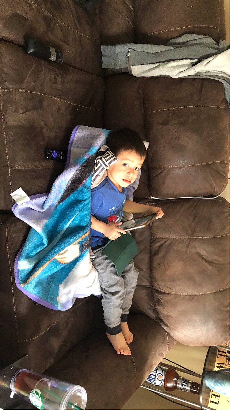 Isaiah is registered to the contest to win money with this photo: auto_part, automotive_tire, automotive_wheel_system, car_seat, child, comfort, flooring, fun, human_leg, leisure, person, room, sandal, shoe, sitting, thigh, toddler, travel
