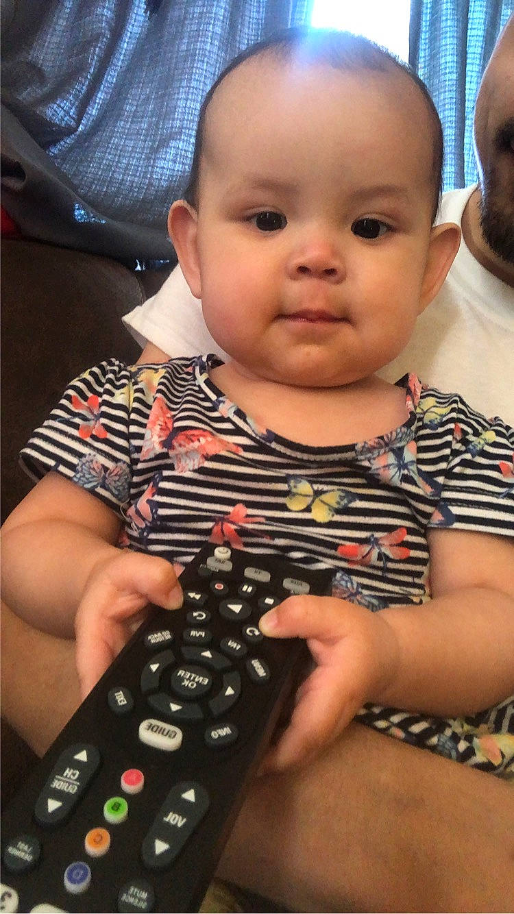 Raelynn is registered to the contest to win money with this photo: baby, baby_toddler_clothing, black, cheek, child, curious, finger, fun, happy, indoor_games_and_sports, input_device, nail, office_equipment, pattern, person, photograph, photography, sitting, snapshot, thumb