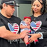 baby, man, woman, family, holding, outdoor, toddler, clothing, headwear, love, affection, matching_outfits, red, black, casual, portrait, smiling, people, hat, bracelet