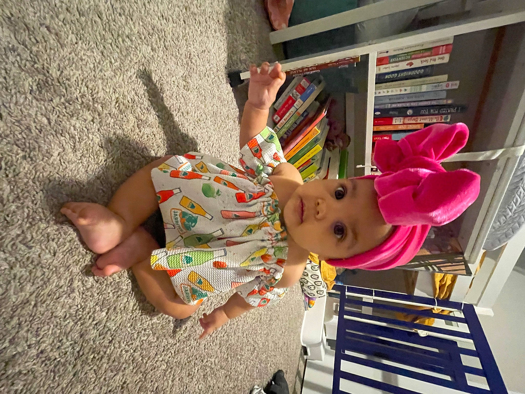 Violet joined the competition — help win amazing prizes! art, baby, baby_toddler_clothing, bookcase, child, dress, foot, fun, headwear, human_leg, leisure, person, room, sandal, shelf, shelving, sitting, toddler, toy, tree