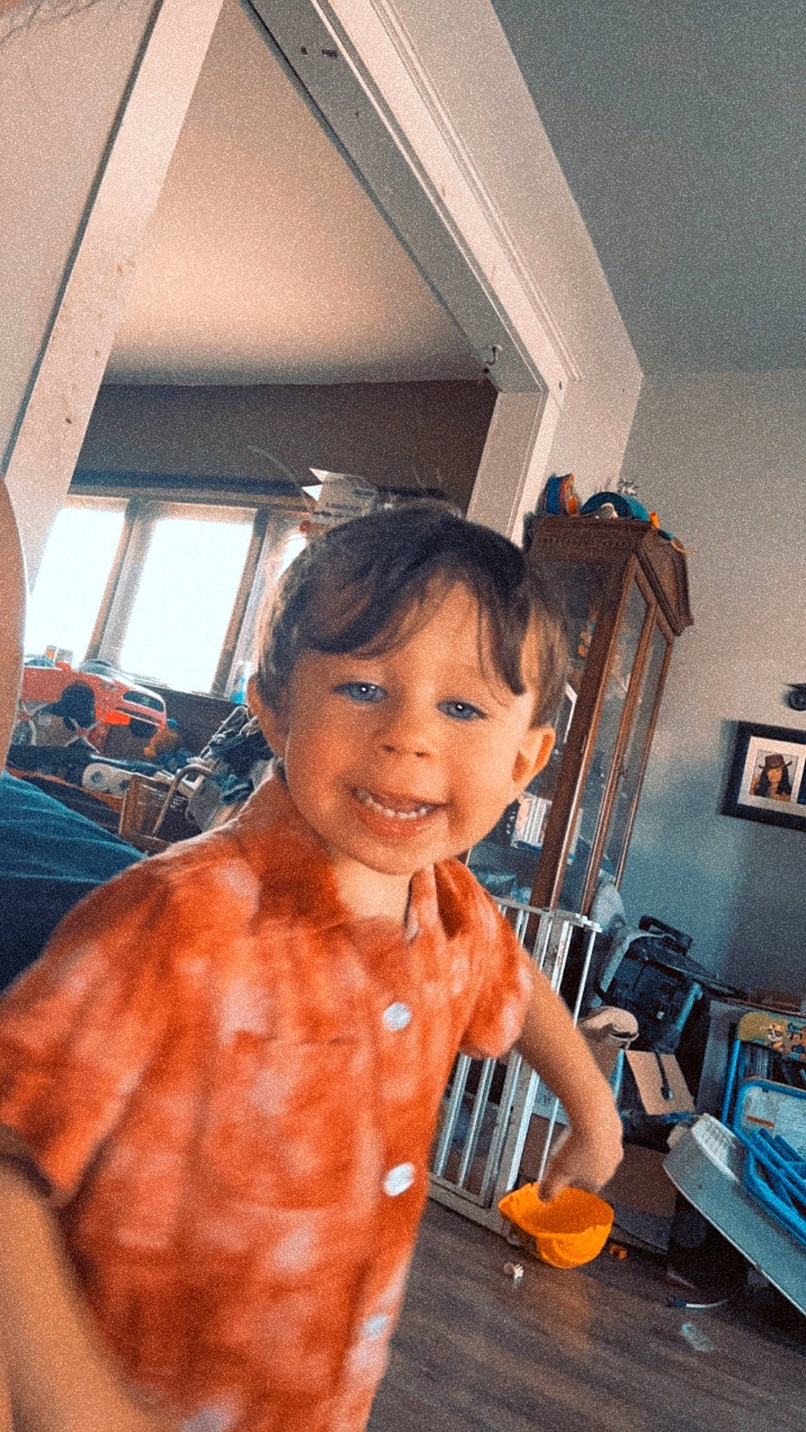 Asher joined the competition — help win amazing prizes! chair, child, flooring, fun, happy, house, joy, orange, person, picture_frame, room, sitting, smile, standing, t_shirt, tableware, toddler, window, wood