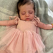 Eleanor is registered to the contest to win money with this photo: baby, child, sleeping, pink_dress, bow, bracelet, blanket, soft_texture, tulle, arms_outstretched, indoor, cozy, resting, cute, infant, peaceful, portrait, person, newborn, hair