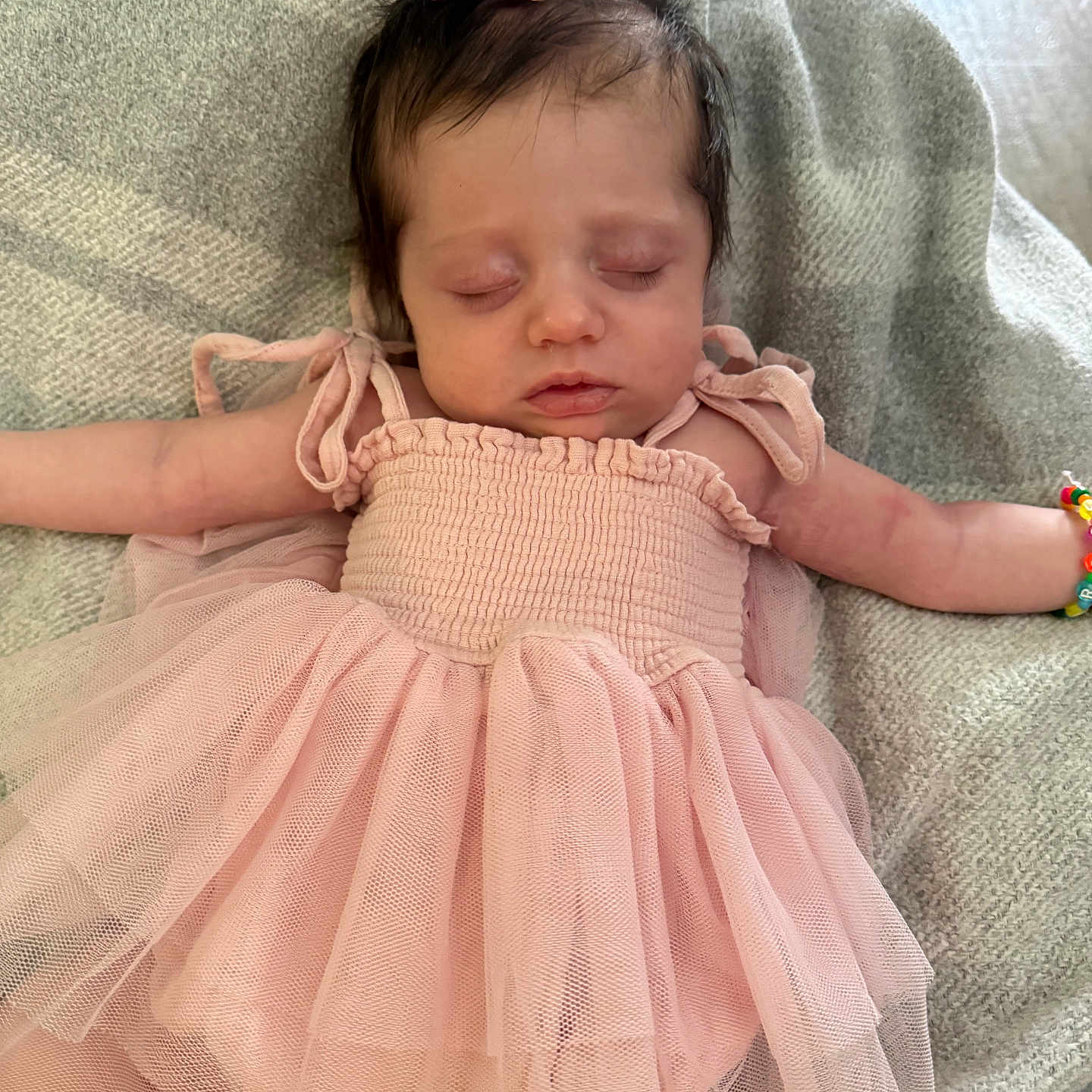 Eleanor is registered to the contest to win money with this photo: baby, child, sleeping, pink_dress, bow, bracelet, blanket, soft_texture, tulle, arms_outstretched, indoor, cozy, resting, cute, infant, peaceful, portrait, person, newborn, hair