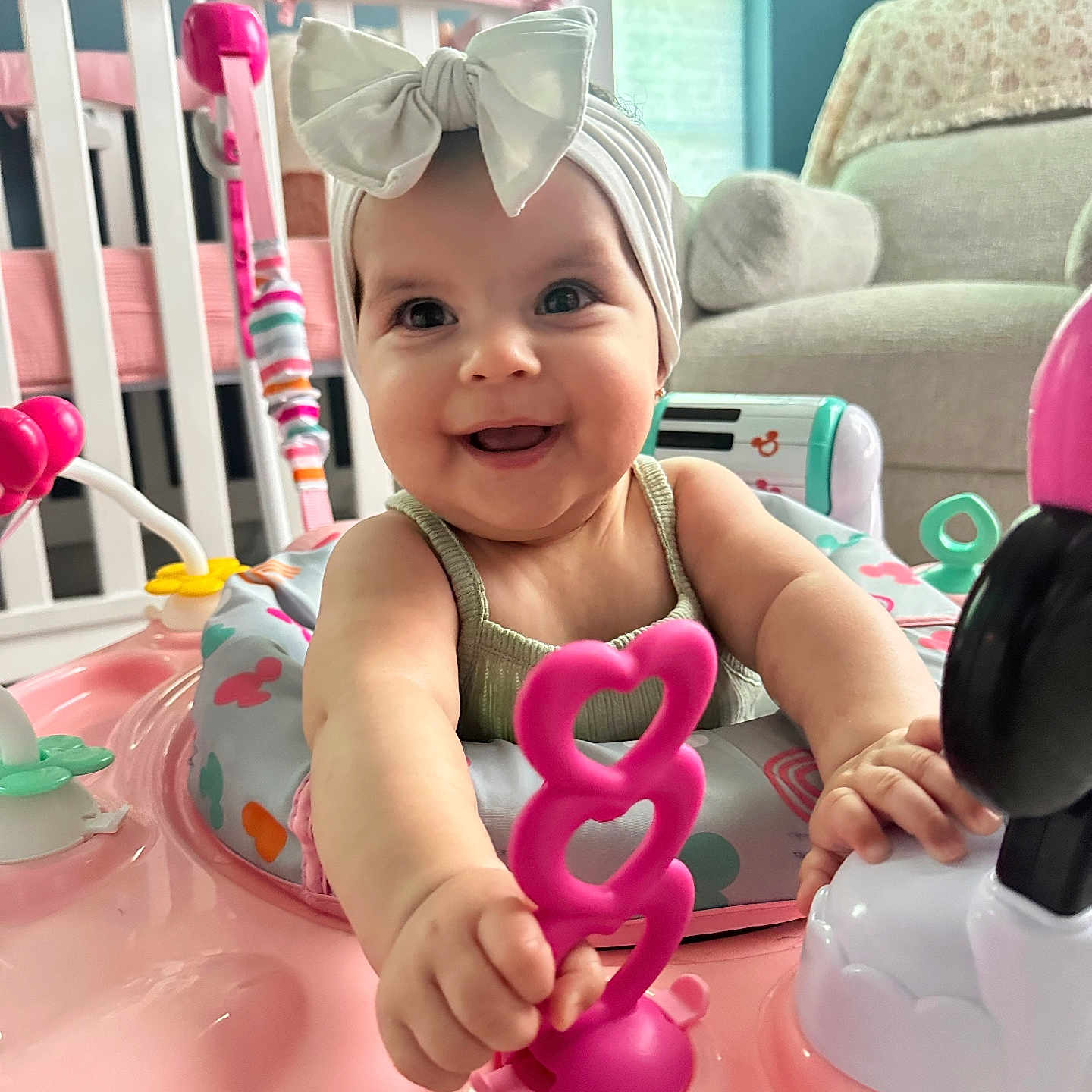 Izabella is registered to the contest to win money with this photo: baby, child, smiling, headband, bow, toy, walker, nursery, crib, chair, indoor, person, cute, infant, playtime, happy, colorful, furniture, closeup, portrait