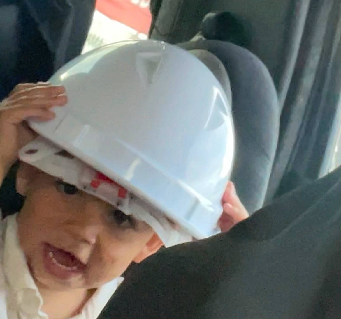 Darrell is registered to the contest to win money with this photo: auto_part, automotive_design, automotive_exterior, automotive_lighting, baby, baby_products, car_seat, child, comfort, fashion_accessory, fun, headwear, helmet, person, personal_luxury_car, personal_protective_equipment, plastic, smile, toddler, vehicle_door