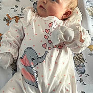 Mariella joined the competition — help win amazing prizes! baby, infant, onesie, elephant, hearts, blanket, cartoon, cute, child, sleepwear, pattern, soft, lying_down, pink, white, face, portrait, clothing, toddler, cute_expression