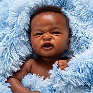 Michael is registered to the contest to win money with this photo: baby, blue_blanket, child, closeup, cozy, curly_hair, cute, expression, face, fuzzy, hand, indoors, infant, newborn, person, portrait, skin, small, soft, wrapped
