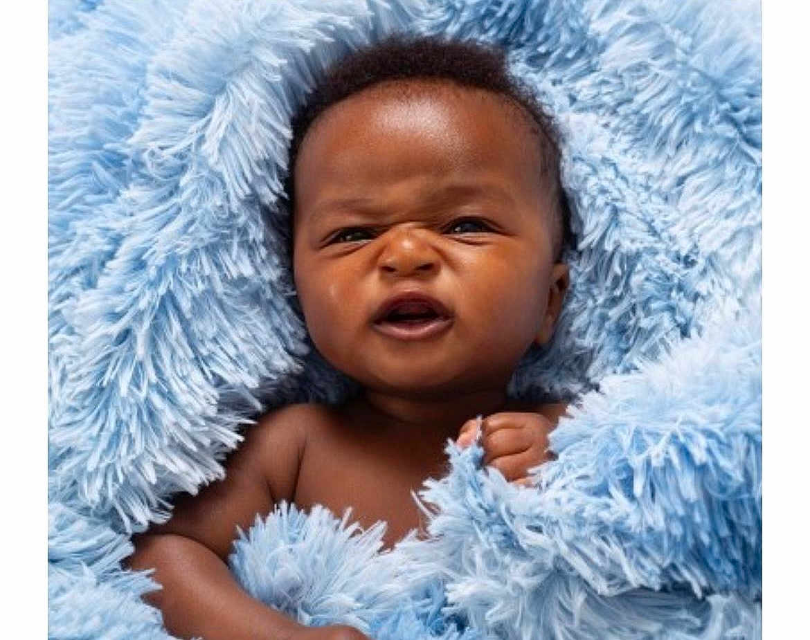 Michael is registered to the contest to win money with this photo: baby, blue_blanket, child, closeup, cozy, curly_hair, cute, expression, face, fuzzy, hand, indoors, infant, newborn, person, portrait, skin, small, soft, wrapped