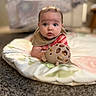 baby, infant, toy, blanket, carpet, floor, indoor, child, cute, face, person, clothing, head, expression, looking, eyes, sitting, soft, furniture, blurred_background