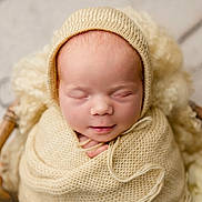 Amara joined the competition — help win amazing prizes! newborn, baby, sleeping, basket, blanket, knitwear, soft, cozy, infant, cute, portrait, cute_baby, closeup, wrapped, resting, peaceful, baby_clothes, headwear, indoors, warm