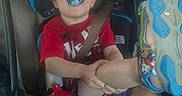 Liam is registered to the contest to win money with this photo: black_hair, car_seat, child, cool, fun, smile, toddler
