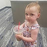 toddler, child, drink, straw, dress, princess, earrings, carpet, office, desk, floor, footwear, indoor, person, young_child, serious_expression, holding, beverage, plastic_cup, standing