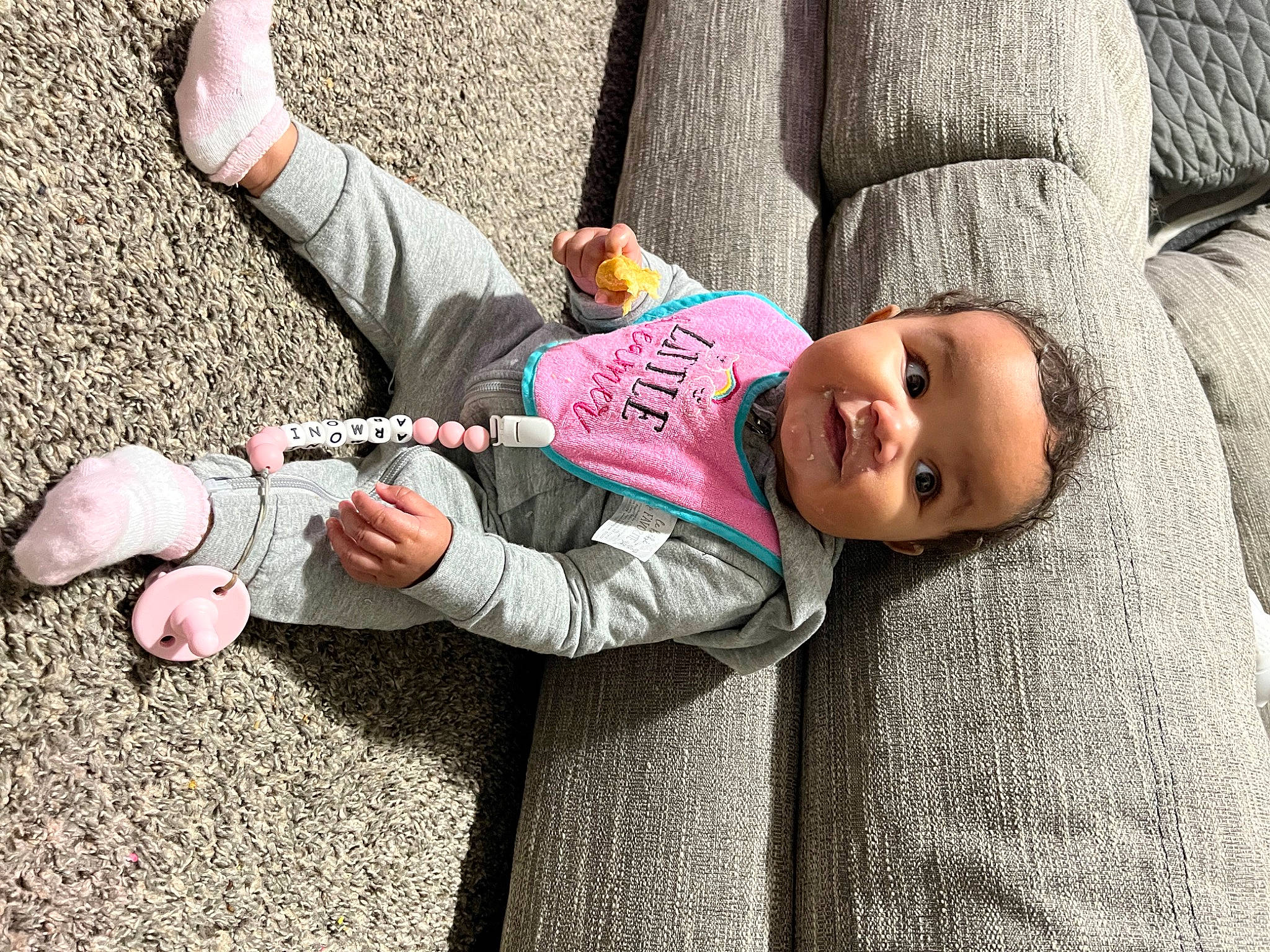 Armoni joined the competition — help win amazing prizes! asphalt, baby, child, comfort, denim, eye, foot, fun, gesture, grass, happy, head, leisure, person, sitting, smile, street, thumb, toddler, tree