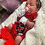 baby, infant, pacifier, red_bow, white_gloves, red_outfit, blanket, soft_texture, sleeping, cute, newborn, portrait, indoor, cozy, tulle, headband, child, resting, human, closeup