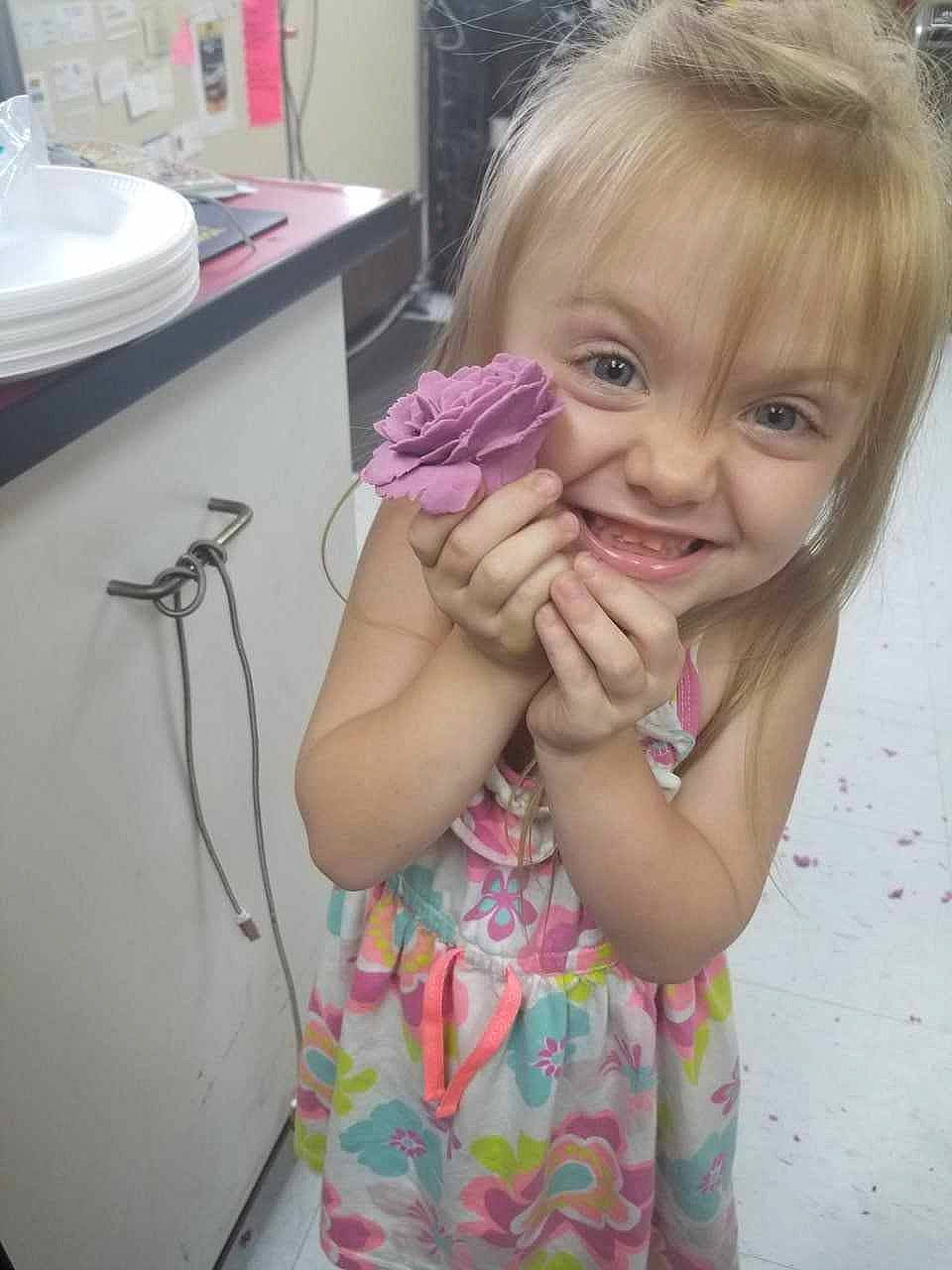 Lillianna is registered to the contest to win money with this photo: arm, baby_toddler_clothing, cheek, child, eyelash, finger, gesture, hand, happy, home_appliance, joy, nose, person, pink, purple, shoulder, skin, smile, standing, tap