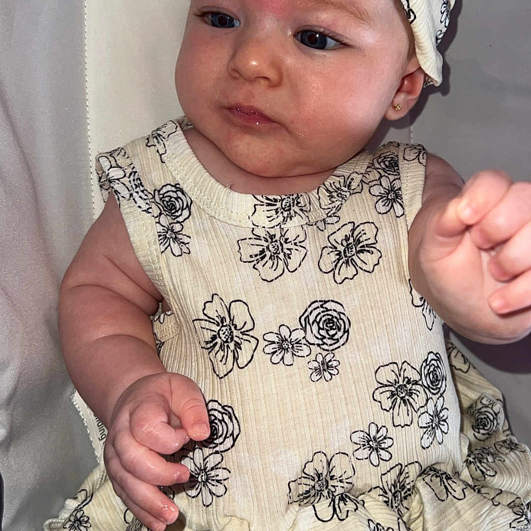 Giavanna joined the competition — help win amazing prizes! baby, child, clothing, cute, dress, earrings, expression, fabric, face, floral_pattern, hand, headband, indoor, infant, light, person, portrait, sitting, skin, young
