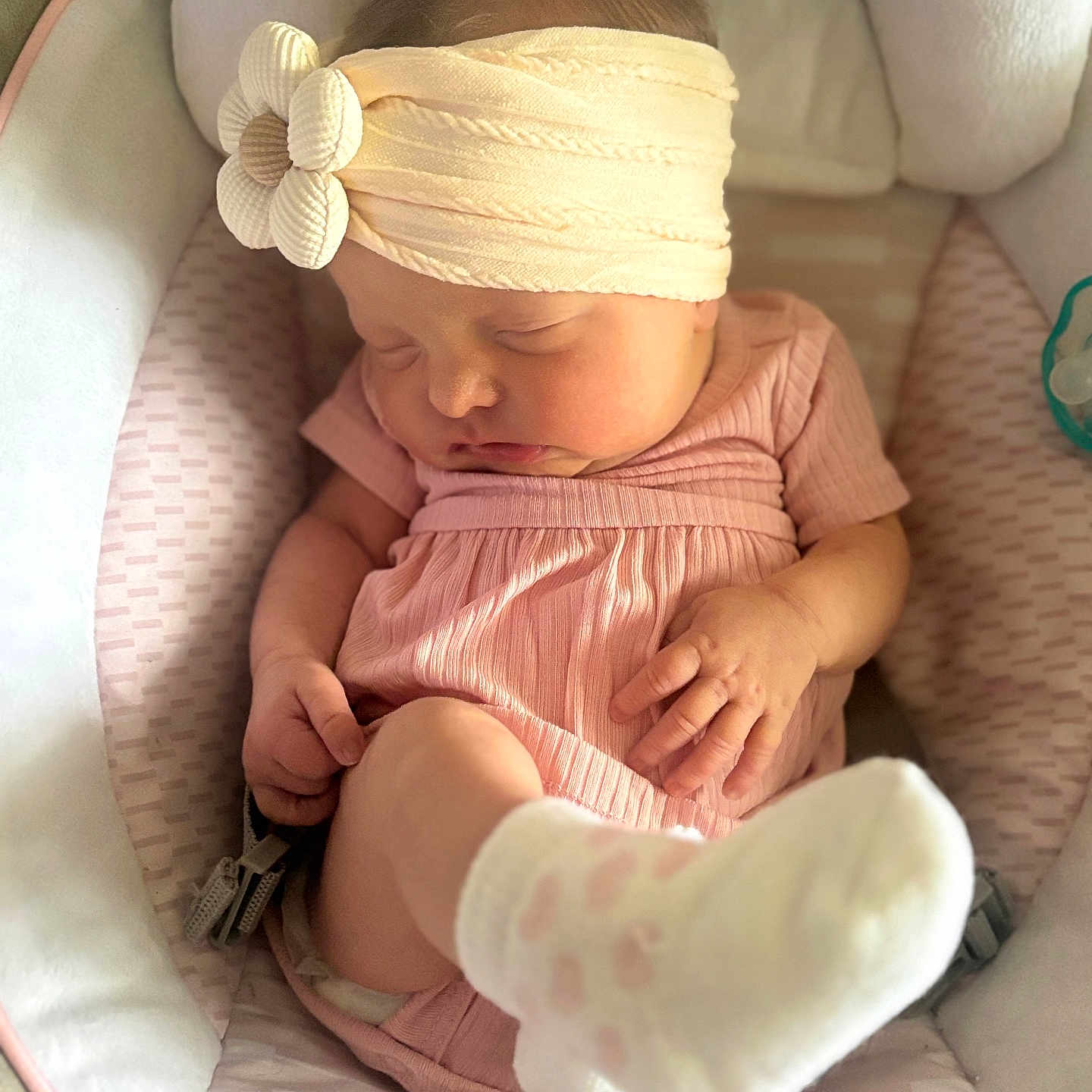 Taylen is registered to the contest to win money with this photo: baby, sleeping, headband, flower, pink_outfit, sock, baby_seat, cushion, infant, peaceful, cute, child, newborn, soft_lighting, indoors, portrait, hands, foot, closeup, relaxing